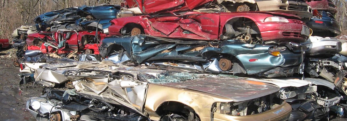 Stack of flattened vehicles in junkyard