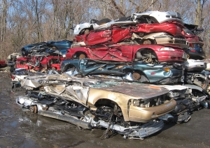Stack of flattened vehicles in junkyard
