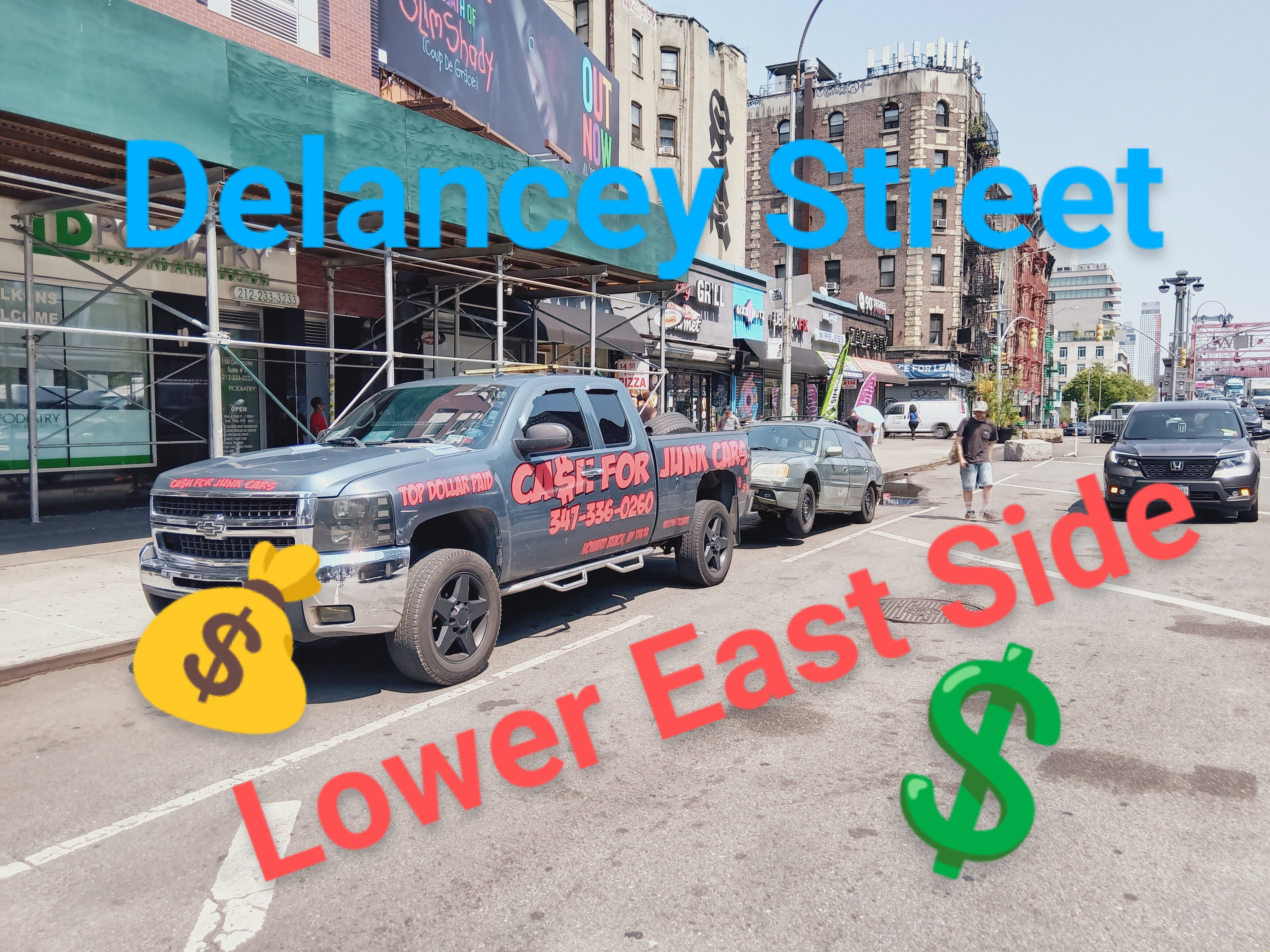 our truck towing a vehicle on Delancey street on the lower east side of Manhattan